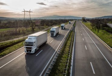 Caravan or convoy of trucks in line on a country highway